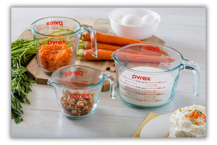 various measuring cups and measuring spoons on a cutting board